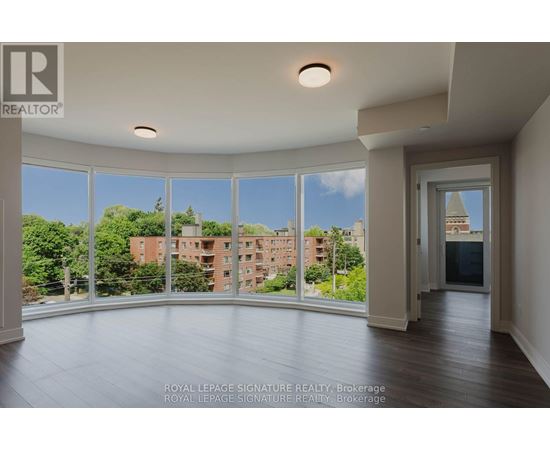 A large, empty room with a view of a cityscape through the windows.