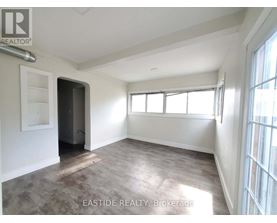 A room with a door and a window is for sale.