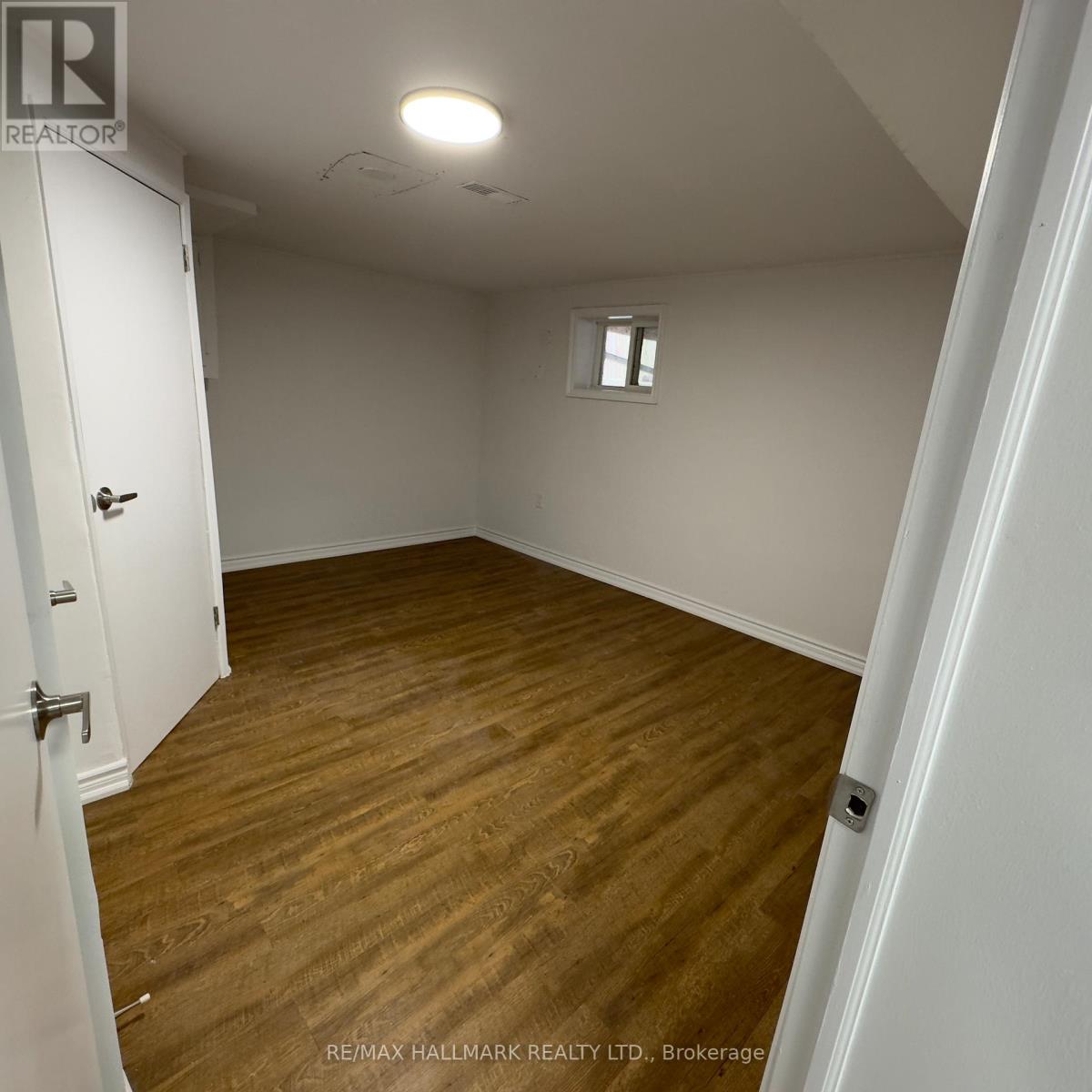 A room with a wooden floor and white walls.