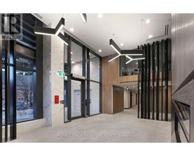A hallway with a glass wall and a white door.