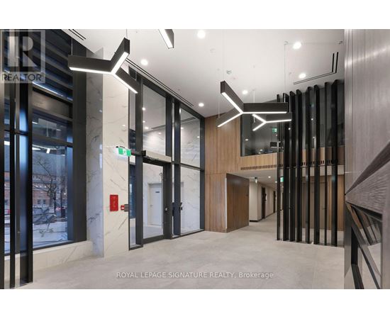 A hallway with a glass wall and a white door.