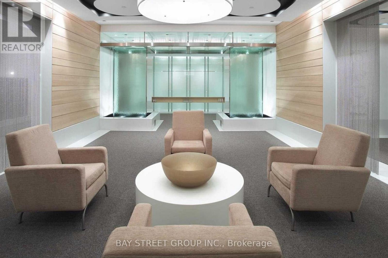 A conference room with a glass wall and a table with chairs.