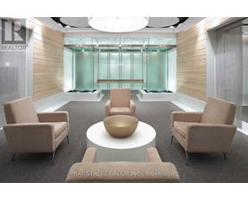 A conference room with a glass wall and a table with chairs.