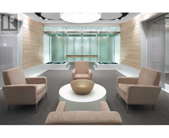 A conference room with a glass wall and a table with chairs.
