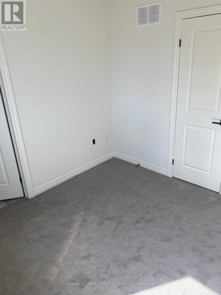 A room with a carpeted floor and a white door.
