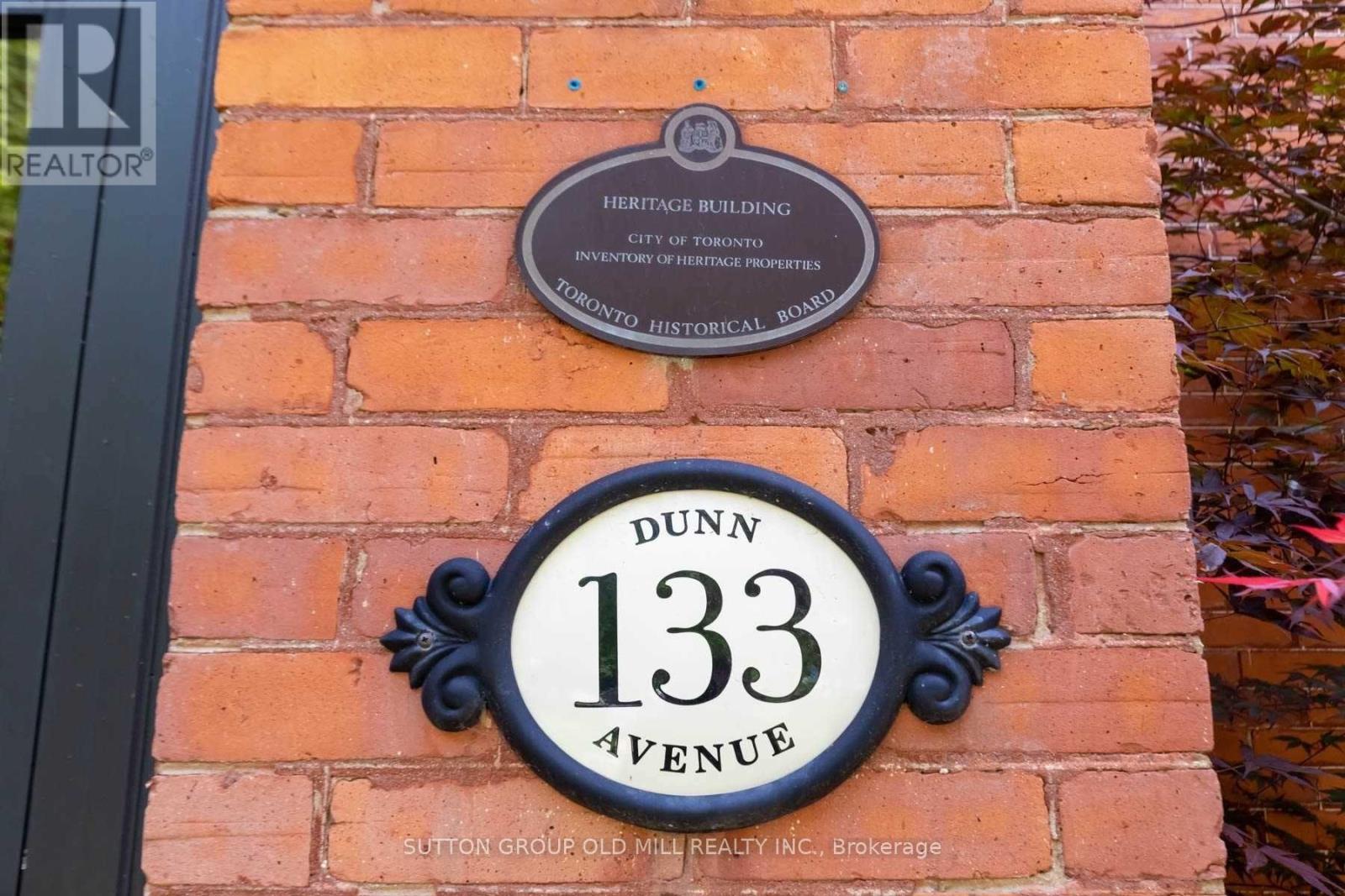 A sign on a brick wall that says Dunn 133 Avenue.