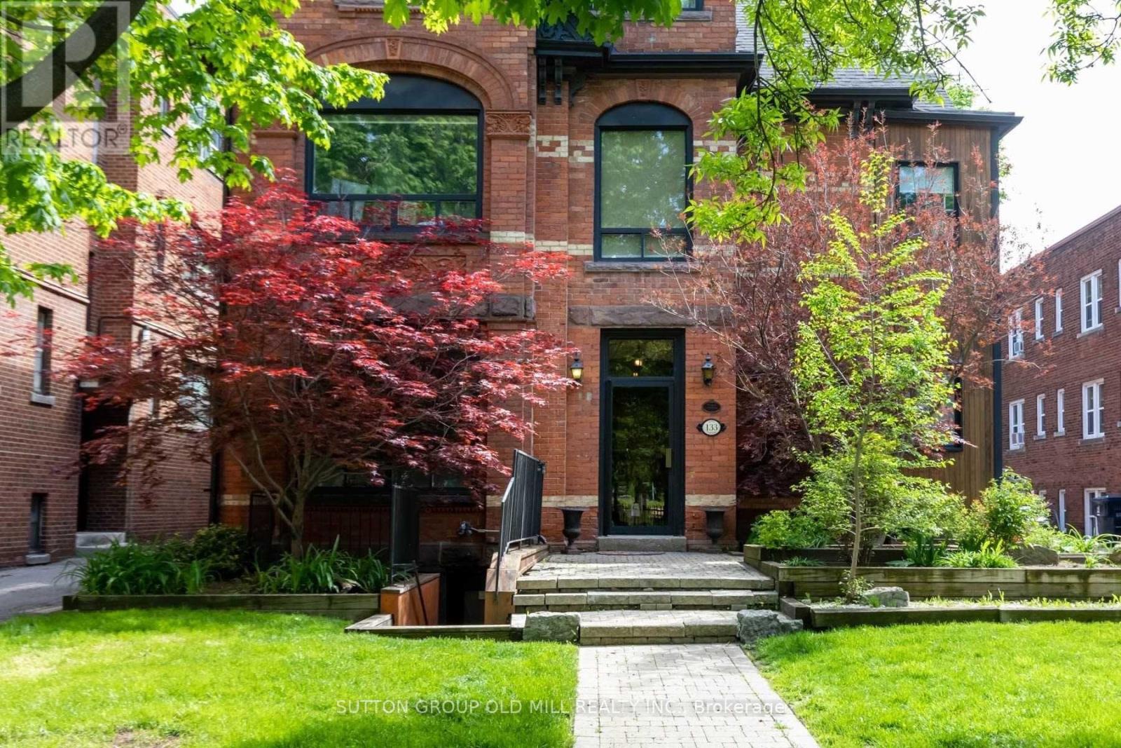 A red brick building with a black door and windows.