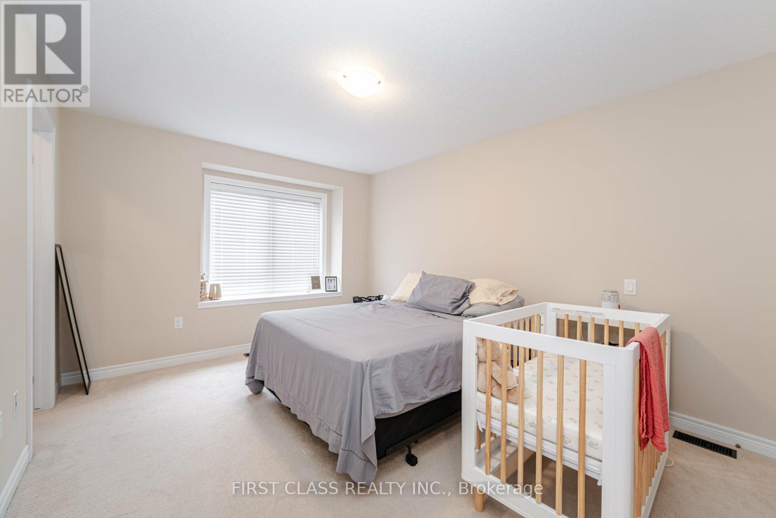 A bedroom with a bed and a crib.