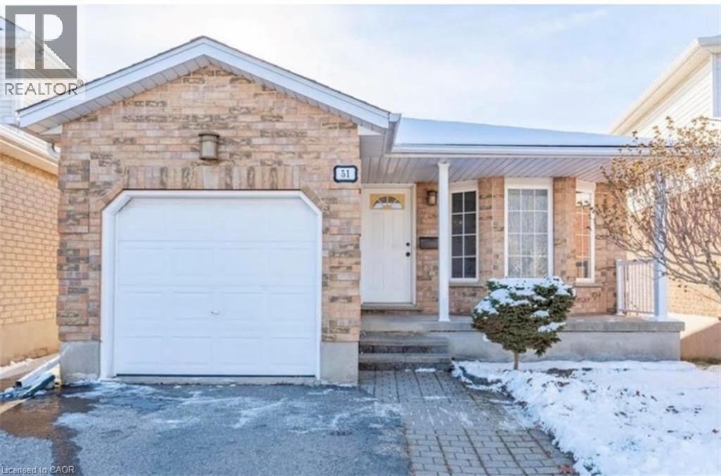 A house with a white garage door and a brick facade.