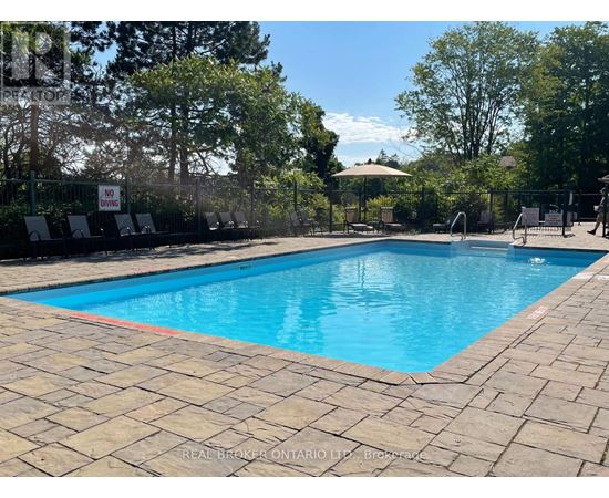 A pool surrounded by trees and a sign that says "No Swimming".