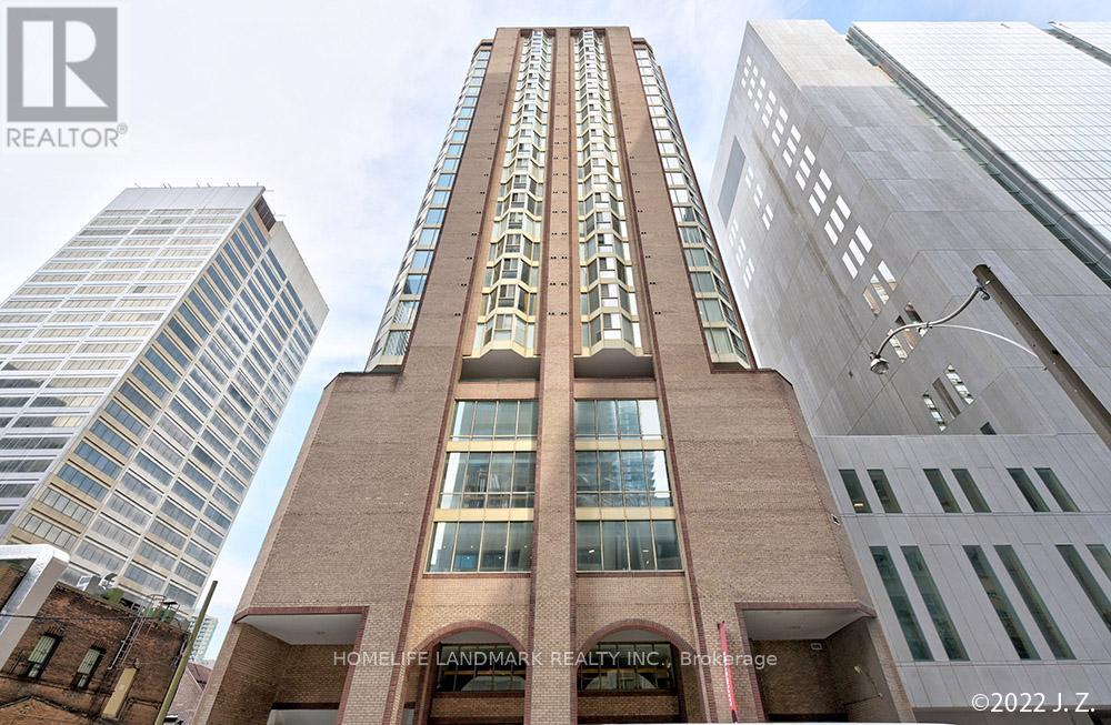 A tall building with a brick facade stands between two modern glass buildings.