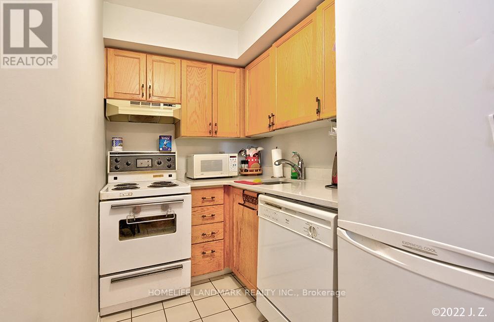 A kitchen with wooden cabinets and white appliances.