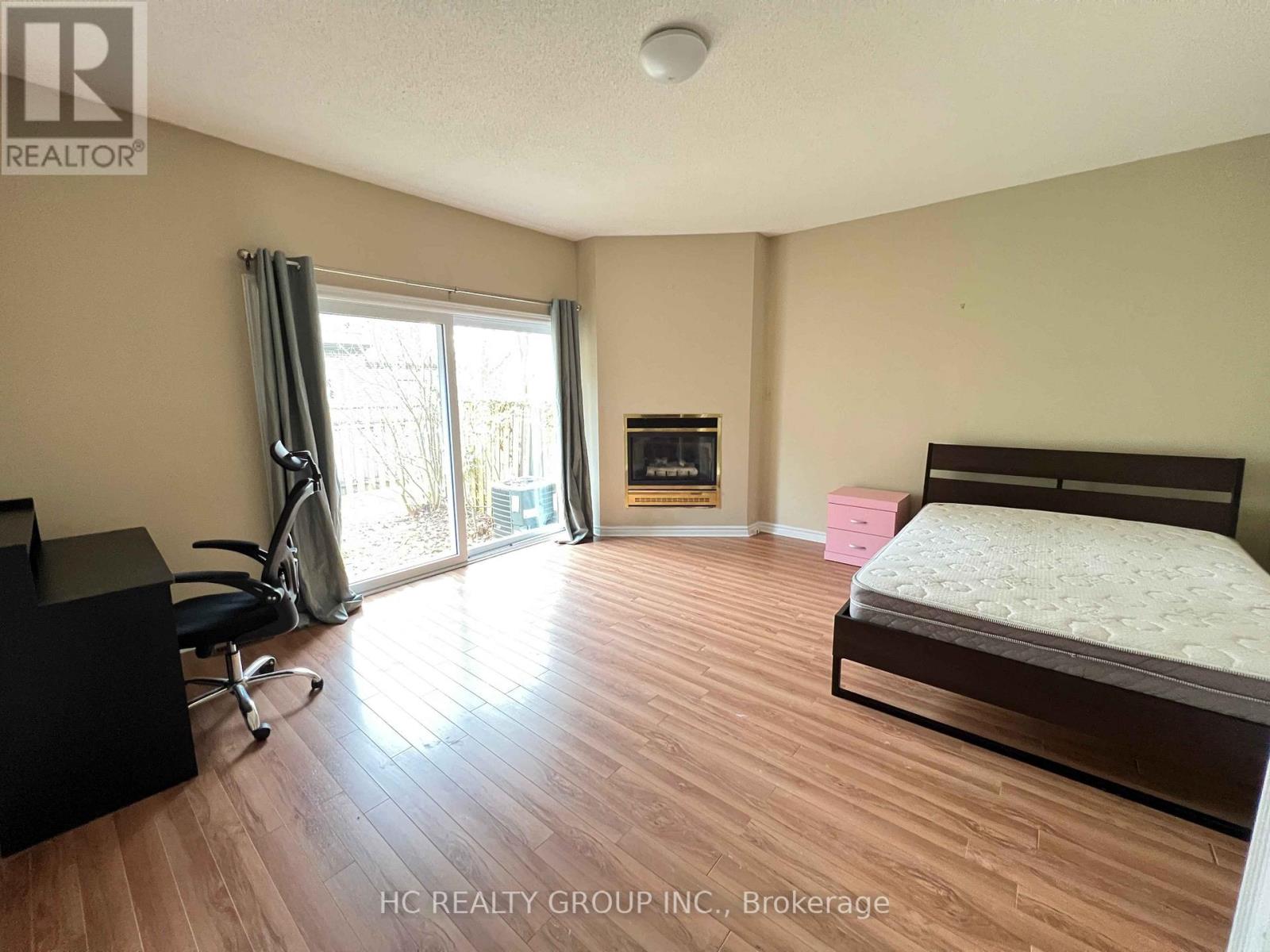 A bedroom with a bed, desk, and chair.