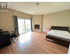 A bedroom with a bed, desk, and chair.
