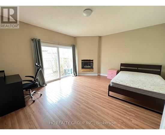 A bedroom with a bed, desk, and chair.