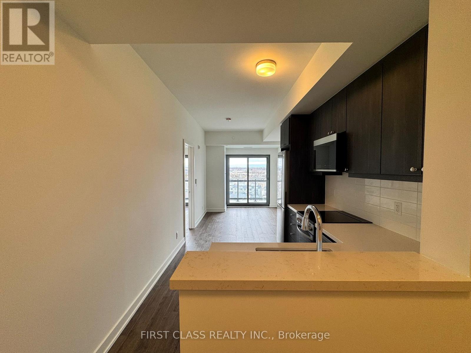 A kitchen area with a sink and a window.