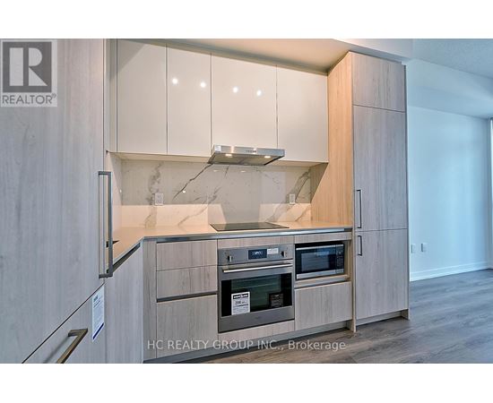 A modern kitchen with wooden cabinets and stainless steel appliances.