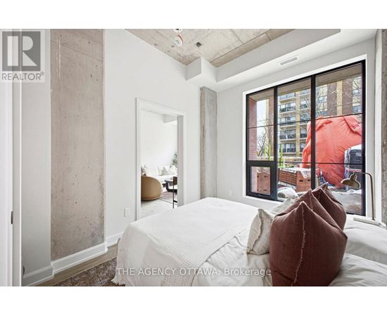 A bedroom with a large bed and a view of the city.
