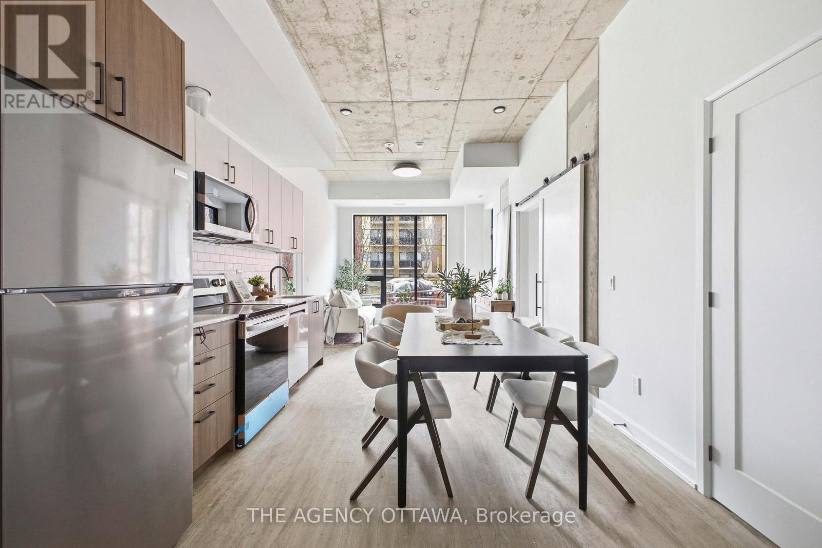 A modern kitchen with a dining table and chairs.
