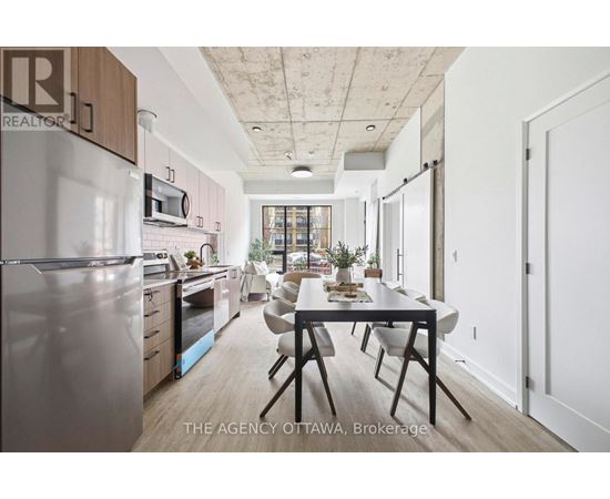 A modern kitchen with a dining table and chairs.