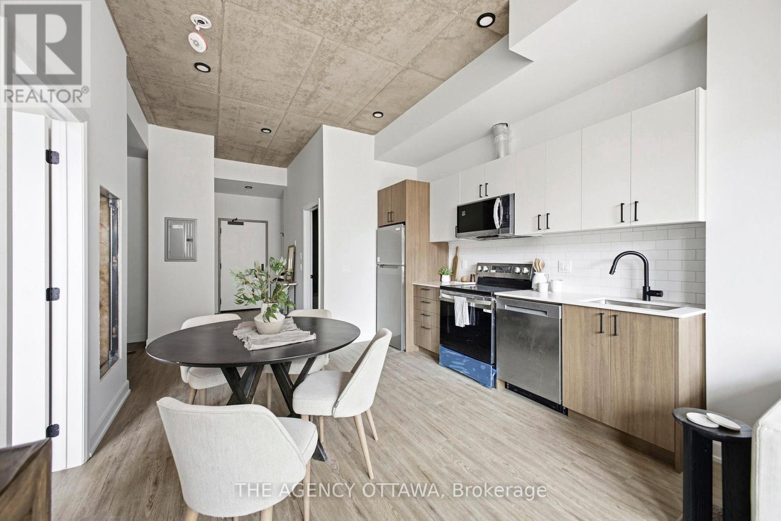 A modern kitchen with a dining table and chairs.