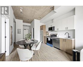 A modern kitchen with a dining table and chairs.