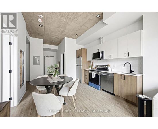 A modern kitchen with a dining table and chairs.
