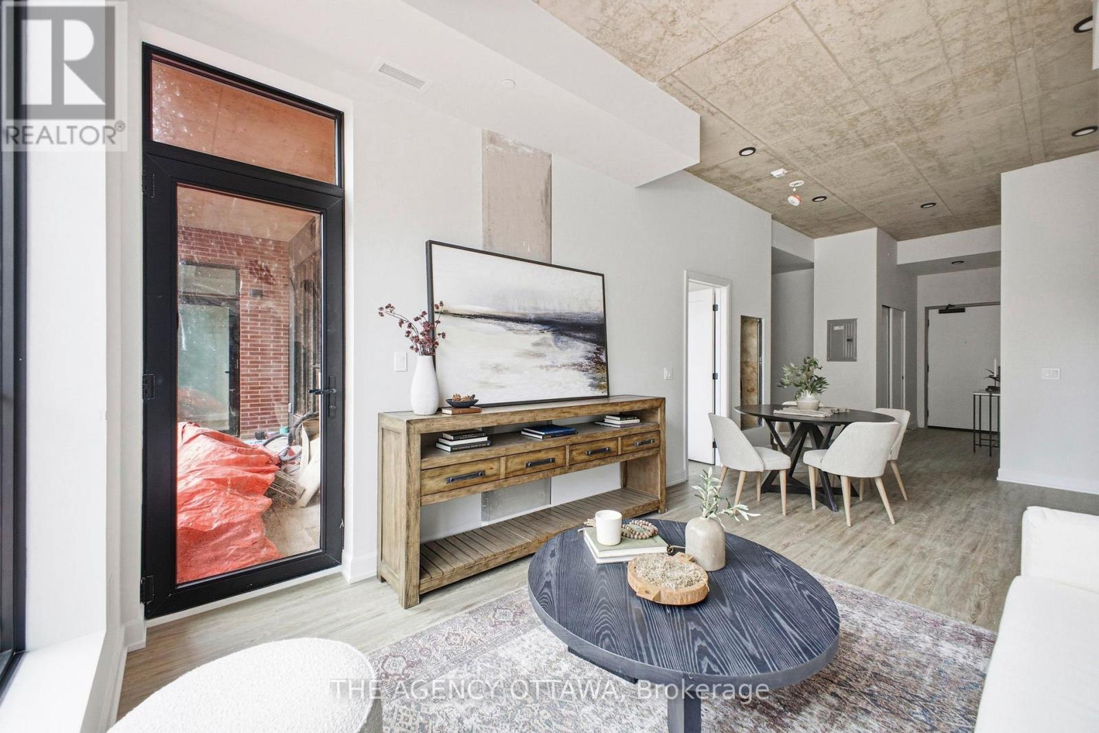 A modern living room with a coffee table in the center.
