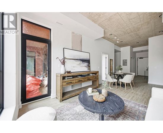 A modern living room with a coffee table in the center.