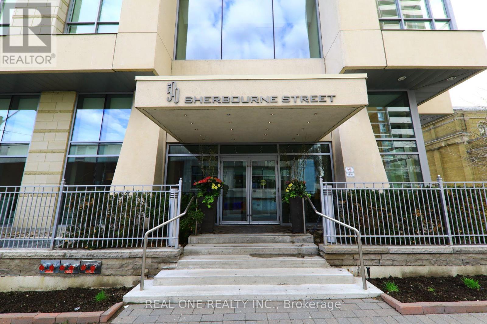 The front of a Sherbourne Street building with a Real One Realty Inc. sign.