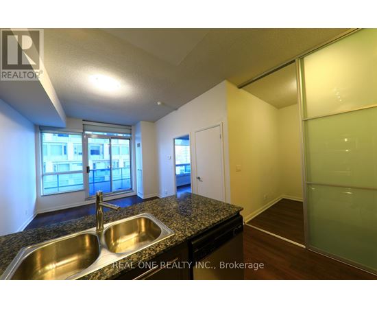 A kitchen with a sink and a window.