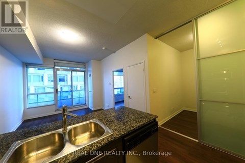 A kitchen with a sink and a window.