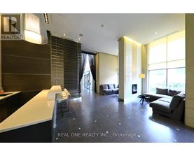A spacious office lobby with a reception desk and a couch.
