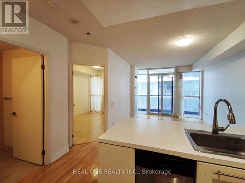 A kitchen with a sink and a window.