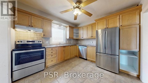 A kitchen with wooden cabinets and stainless steel appliances.