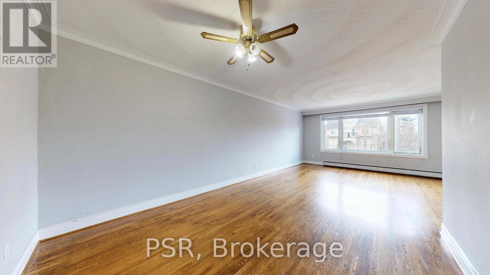 A room with a ceiling fan and wooden flooring is for sale.