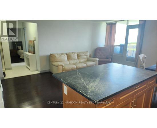 A living room with a black countertop and a brown armchair.