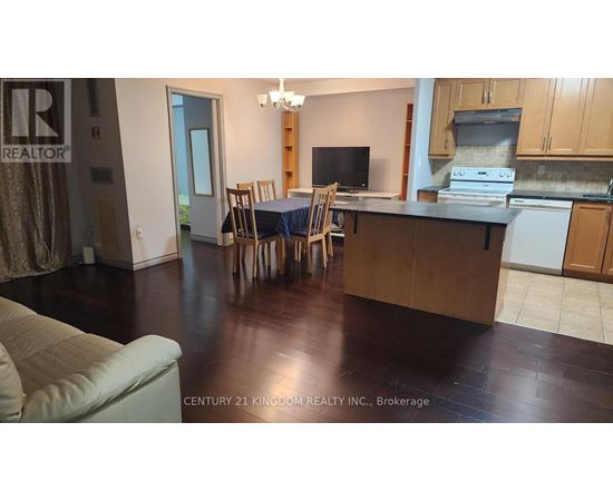 A kitchen with a dining table and chairs.