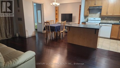 A kitchen with a dining table and chairs.