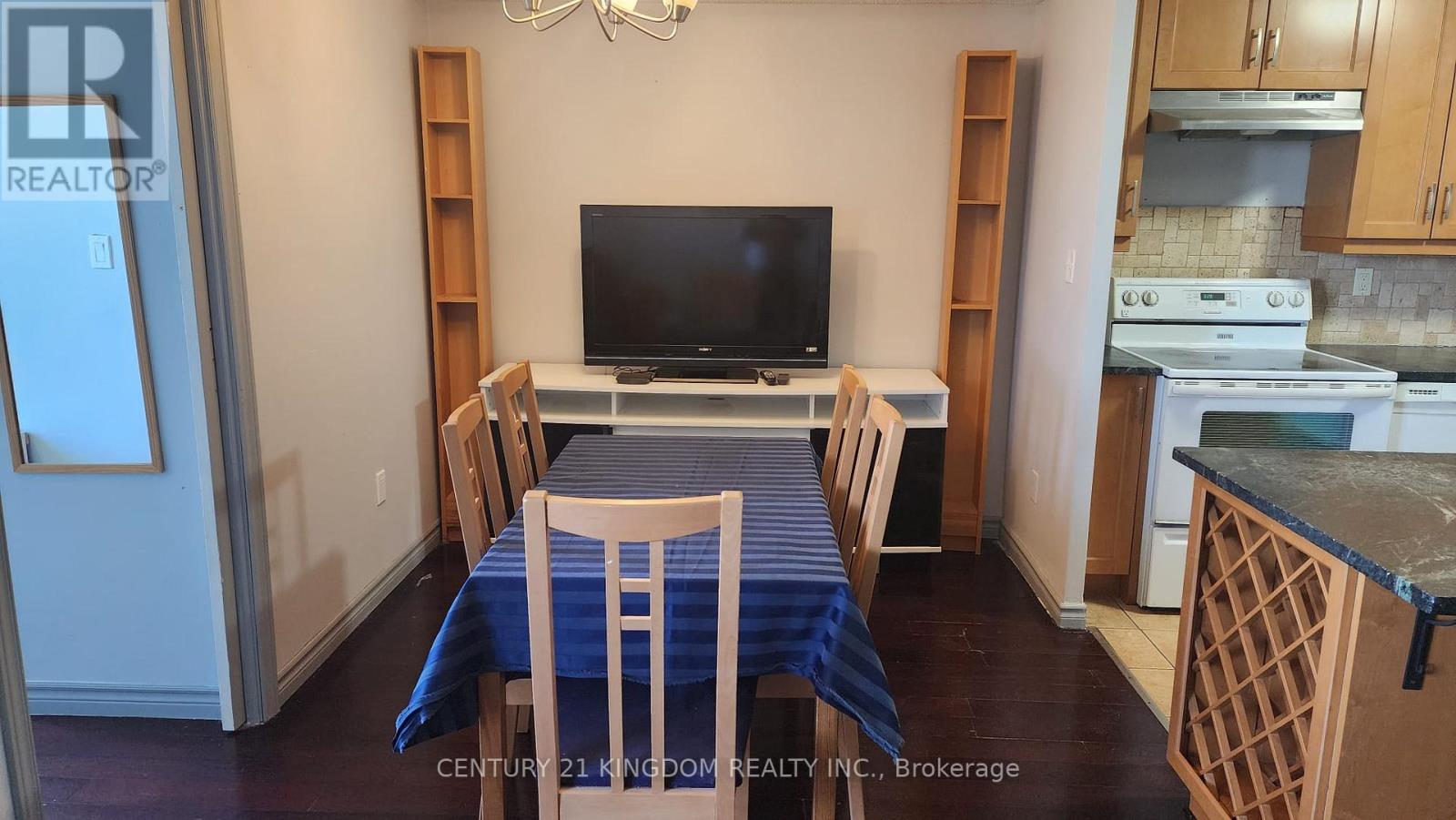 A dining room with a table set for four.