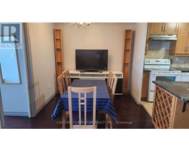 A dining room with a table set for four.