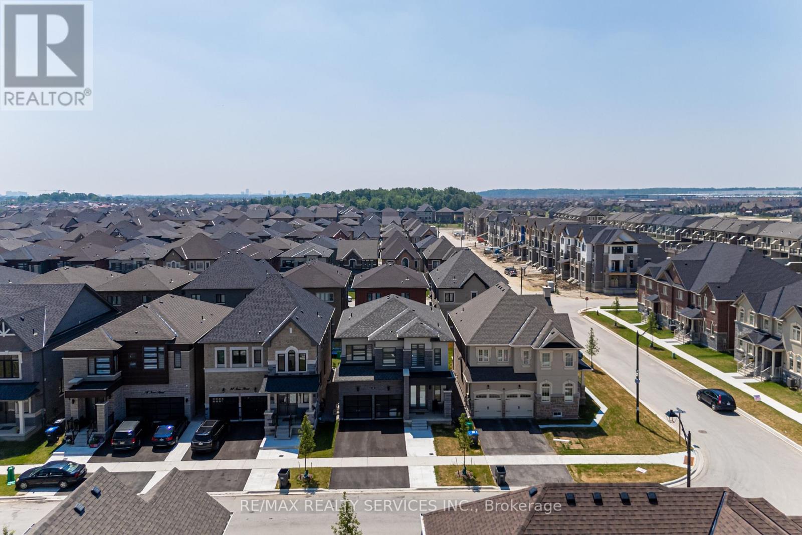 A bird's eye view of a residential area with houses and cars.