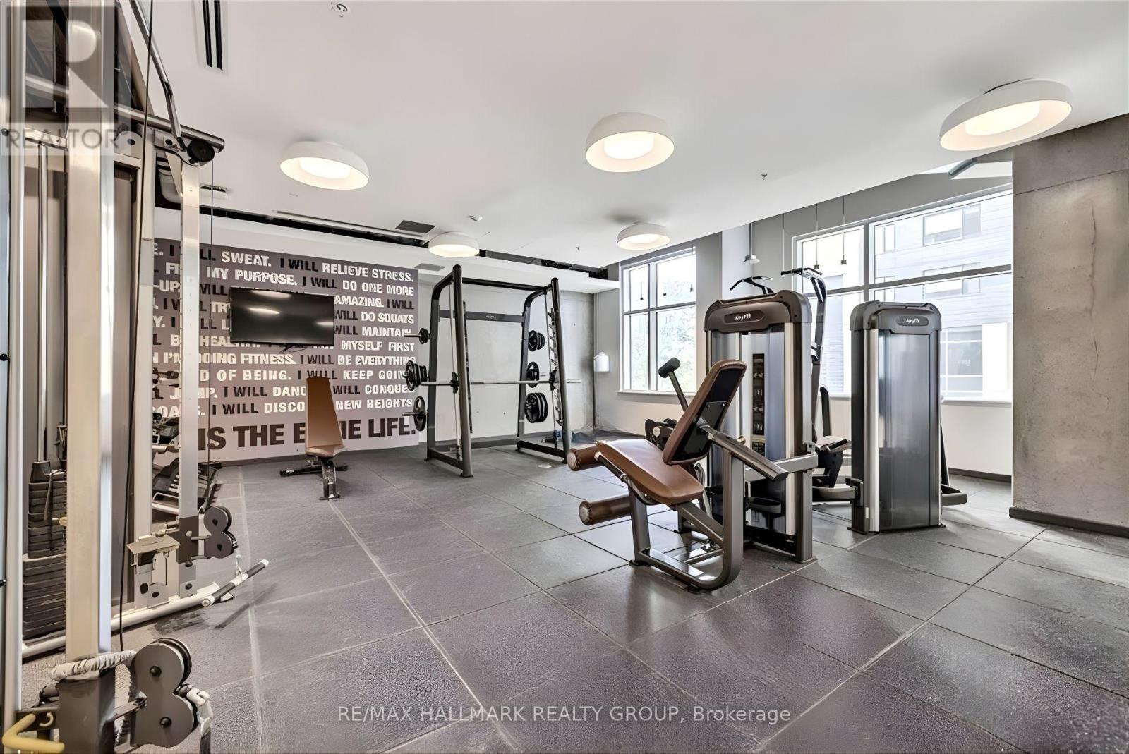 A gym with a sign that says "sweat is the best medicine".