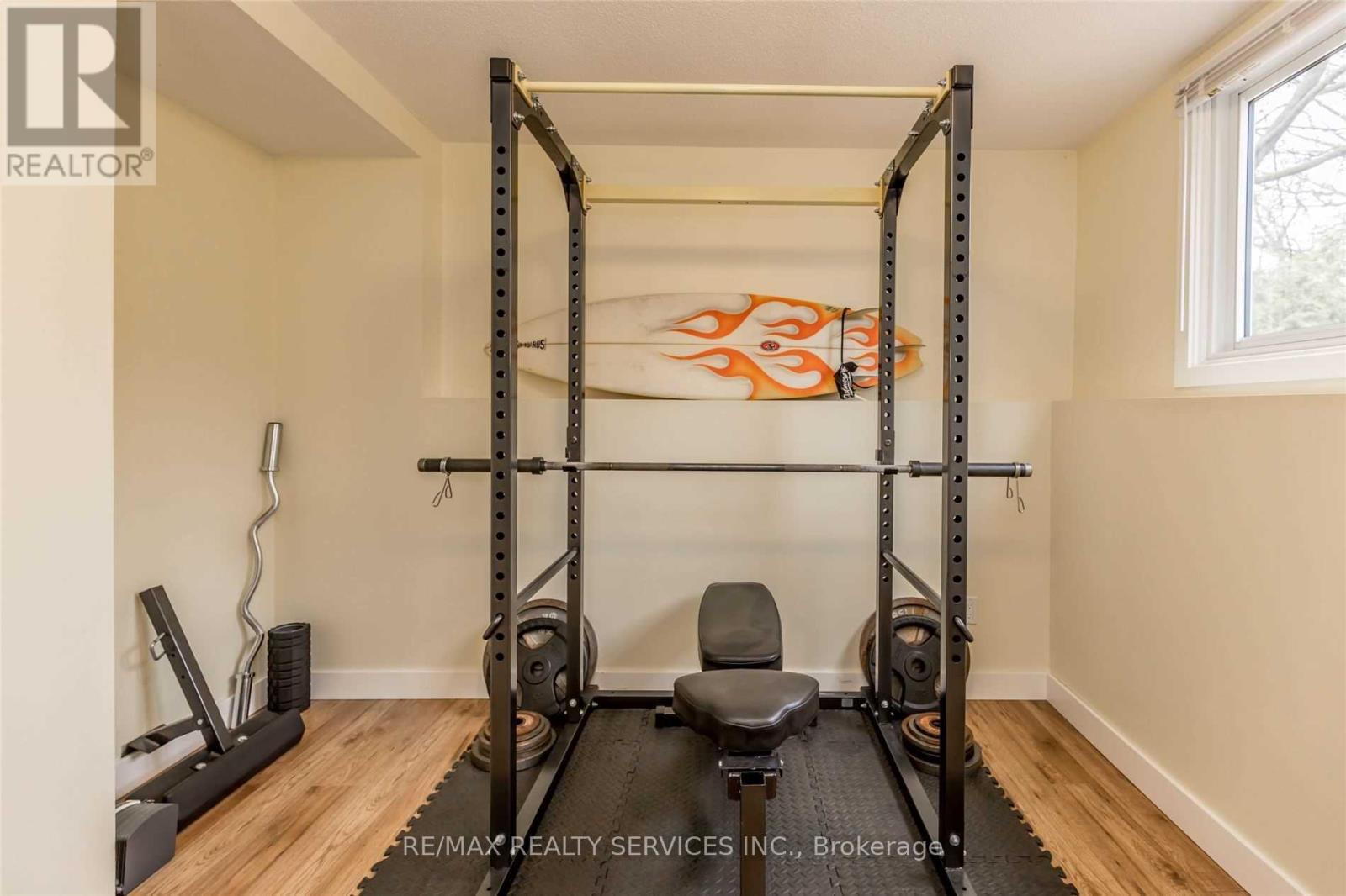 A home gym with a squat rack, bench, and weights.