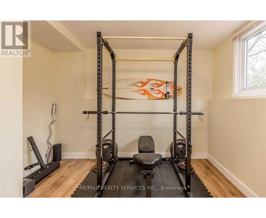 A home gym with a squat rack, bench, and weights.