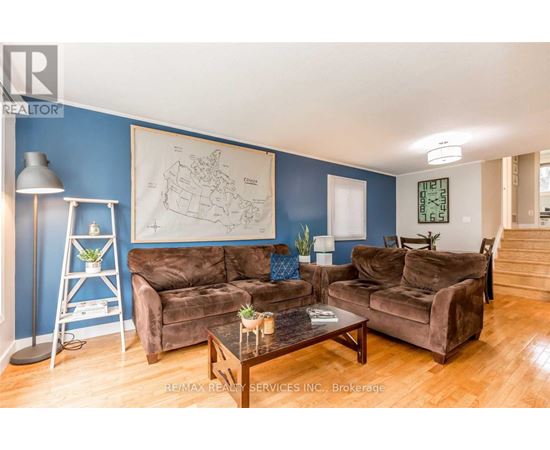 A living room with brown couches and a blue wall.