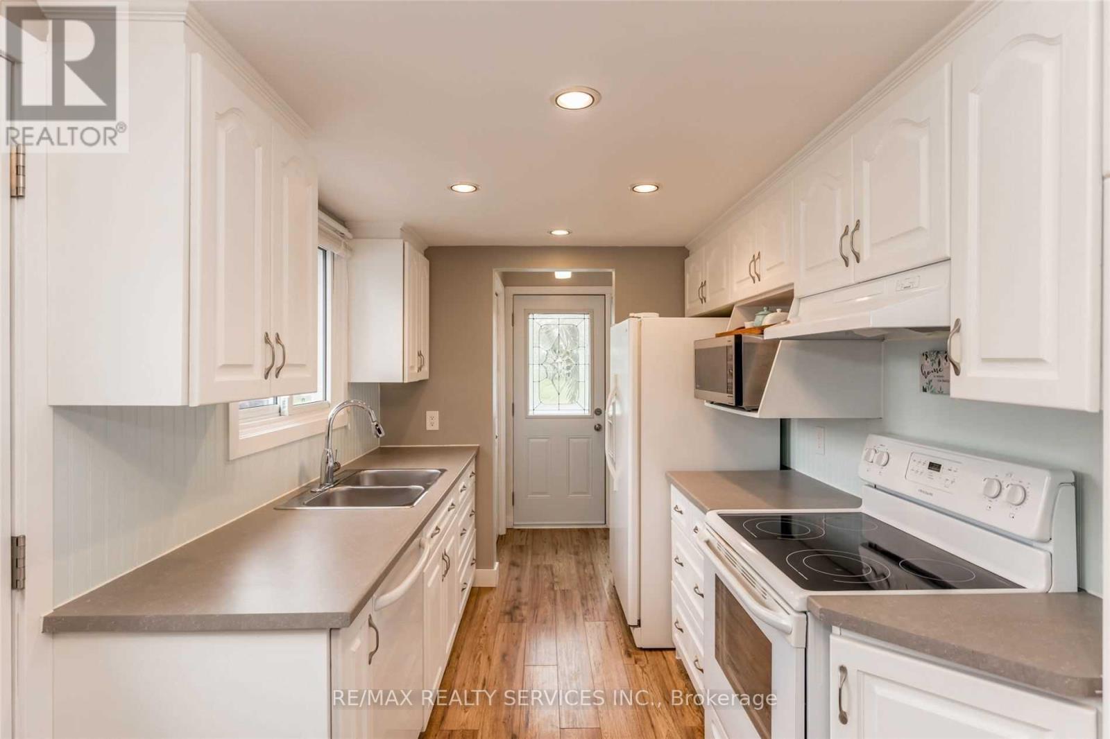 A kitchen with white cabinets and stainless steel appliances.