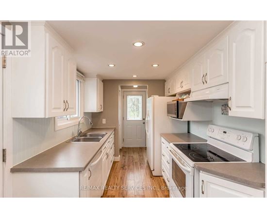 A kitchen with white cabinets and stainless steel appliances.