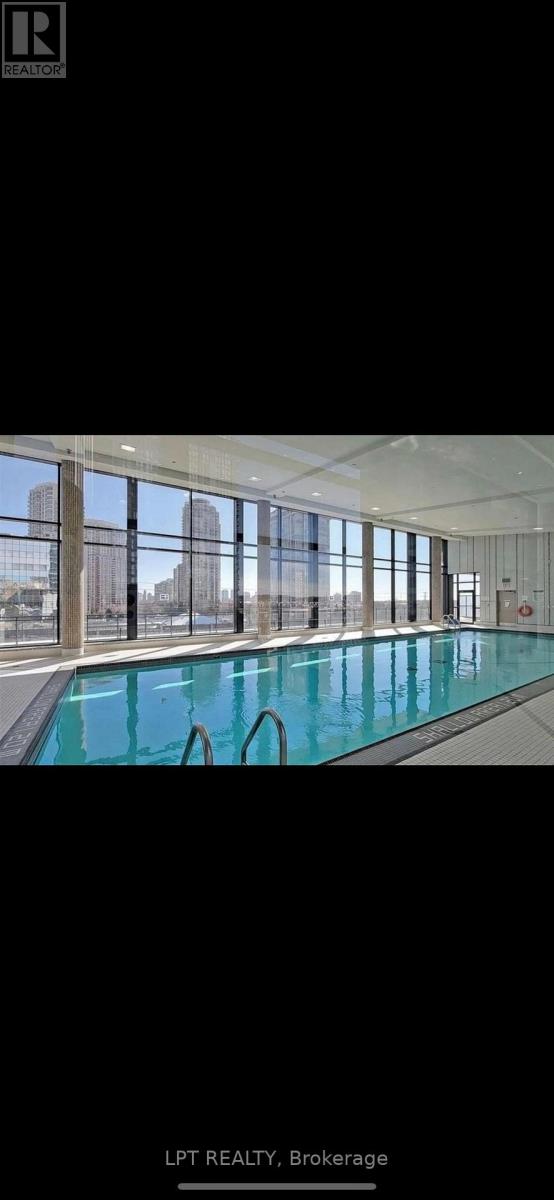 A large indoor swimming pool with a view of the city.