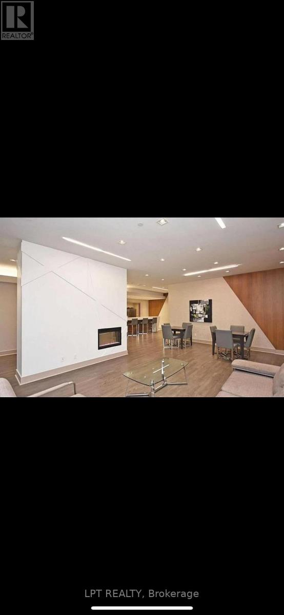 A modern living room with a fireplace and a large painting on the wall.